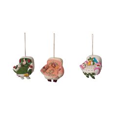 three ornaments are hanging in the shape of sheeps