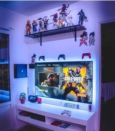 an entertainment center with various video game action figures on the wall and shelves above it