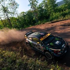 a rally car driving down a dirt road