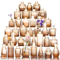 a large collection of vases and flowers are arranged in the shape of a pyramid