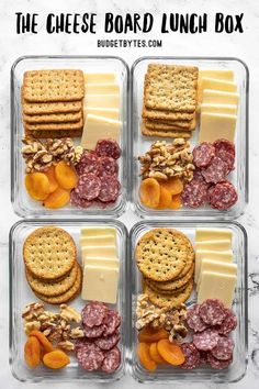 four plastic containers filled with crackers, cheese and meats on top of each other