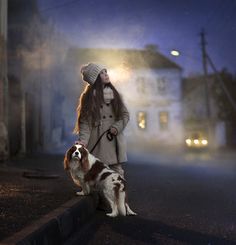 a woman walking her dog on a foggy street at night with the moon in the background