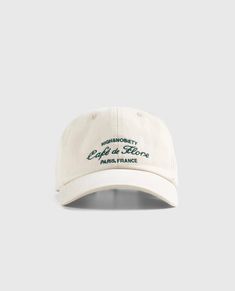 Iconic CAFE DE FLORE x HIGHSNOBIETY limited edition hat inspired by the chicest cafe in Paris. PRINT METHOD: Embroidery CARE: Hand wash with care DELIVERY: Please note, all orders will be processed immediately and dispatched within 2-5 days, depending on order volume at the given period but we will happily try to expedite all orders. Depending on the destination country and shipping method chosen, international orders can take 5-7 business days to deliver but usually it is much quicker and exped White Retro Hat With Logo Patch, Retro White Hat With Logo Patch, Retro Hats With Embroidered Logo And Curved Bill, Vintage White Baseball Cap With Curved Bill, Retro Curved Bill Hat With Embroidered Logo, Vintage Dad Hat With Embroidered Logo And Curved Visor, Classic Cream Hats With Embroidered Logo, Vintage White Cotton Dad Hat, Vintage Six-panel Hats For Spring