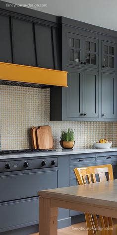 a kitchen with gray cabinets and yellow accents on the counter tops, along with a wooden dining table