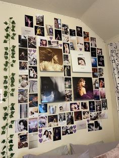 a bedroom wall covered in pictures and photos next to a bed with pillows on top of it