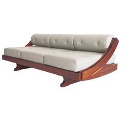 a white couch sitting on top of a wooden frame