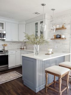 a kitchen with an island and two stools