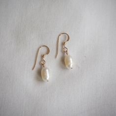 These pearl earrings are simple yet elegant and are a staple in any jewelry collection. These earrings are effortlessly versatile and their small size makes them perfect for wearing anywhere! Bring them out to grab a coffee, wear them to school or work, or take them for a night out! They're ready to go wherever you go.  ➤【 PLEASE READ 】➤ ✿ IMPORTANT ✿ Due to the organic nature of freshwater pearls, each pearl will differ slightly in size and shape and may feature small marks, white lines/spots, Minimalist Nickel-free Pearl Earrings For Formal Occasions, Minimalist Hypoallergenic Pearl Earrings For Formal Events, Everyday 14k Gold Pearl Drop Earrings, Minimalist Pearl Drop Earrings For Everyday, Everyday 14k Gold Filled Earrings With French Hook, Minimalist 14k Gold Dangle Pearl Earrings, 14k Gold Pearl Earrings For Everyday, Everyday 14k Gold Pearl Earrings With Ear Wire, Minimalist Gold Bridal Earrings In Sterling Silver