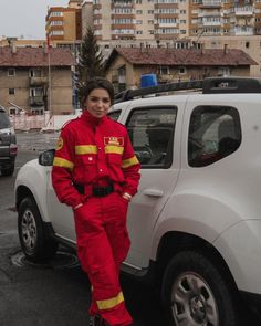 a woman standing next to a white suv