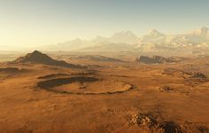 an aerial view of the desert with mountains in the background