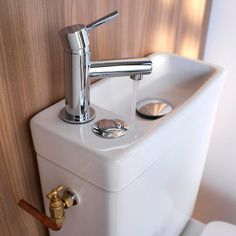 there is a white sink with chrome faucet on the wall next to it