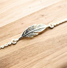 Discover the perfect blend of elegance and bohemian charm with our stunning 925 Sterling Silver Feather Bracelet. Handcrafted with love and precision, this exquisite piece is designed to be both versatile and timeless. Adorn your wrist with a delicate feather motif, meticulously crafted from premium 925 sterling silver, ensuring you shine with a touch of nature-inspired beauty. Measuring 7/8 inches in width and 3/16 inches in length, this bracelet is adjustable from 6 1/2 inches to 7 1/2 inches, making it a perfect fit for any wrist size. Crafted with the highest quality materials, this sterling silver bracelet is stamped with the coveted 925 mark, symbolizing its purity and authenticity. Whether you're dressing up for a special occasion or adding a touch of sophistication to your everyday Bohemian Sterling Silver Bracelets For Party, Bohemian Sterling Silver Bracelet For Parties, Bohemian Sterling Silver Party Bracelets, Bohemian Bracelets With Lobster Clasp For Party, Bohemian Party Bracelets With Lobster Clasp, Silver Bohemian Charm Bracelet For Party, Silver Feather Bracelet, Feather Bracelet, Silver Feather