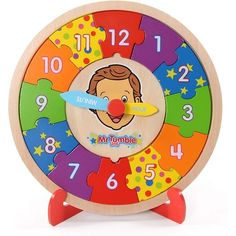 a wooden clock with colorful puzzles on it's face and numbers in the middle