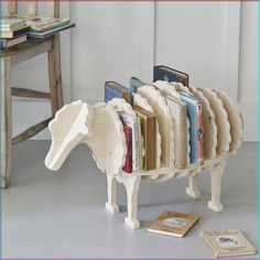 a toy horse made out of books sitting on the floor