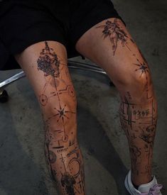 a person sitting down with tattoos on their legs