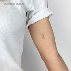 a woman's arm with a small tattoo on the left side of her arm