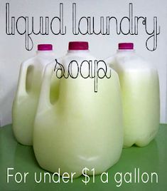 three jugs of liquid sitting next to each other on a green table with the words laundry laundry soap