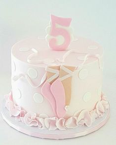 a pink and white birthday cake with a number 5 on it's bottom tier