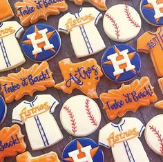 decorated cookies are displayed on a tray for the guests to enjoy their baseball themed treats