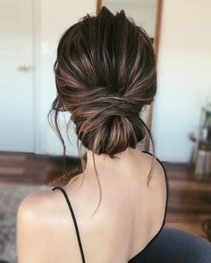 a woman with her hair in a low bun