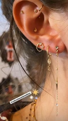 a close up of a person's ear with some piercings on it,