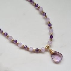 Amethyst Gemstone Necklace ~ Beautiful wire wrapped lavender teardrop faceted amethyst gemstone with purple and lavender faceted amethyst gemstone beads and gold square beads on 14k gold fill Figaro chain.  Amethyst pendant 13X19mm Adjustable 18.5-19.5" *Listing is for the necklace in the first photos ready to ship. SHOP~ http://www.etsy.com/shop/HanaMauiCreations?ref=si_shop International buyers please read our shipping policies before ordering~ POLICIES~ https://www.etsy.com/shop/HanaMauiCreat Purple Teardrop Gemstone Necklace, Lavender Amethyst Teardrop Necklace, Lavender Teardrop Amethyst Necklace, Amethyst Teardrop Pendant For Jewelry Making, Teardrop Amethyst Pendant For Jewelry Making, Teardrop Amethyst Jewelry For Healing, Lavender Amethyst Drop Necklace, Lavender Natural Stones Jewelry For Meditation, Purple Amethyst Teardrop Gemstone