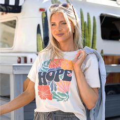 Vibrant And Full Of Life, The Hope Graphic Tee Is A Colorful, Encouraging Reminder To Add To Your Graphic T Shirt Line Up This Season! Custom Designed, This Top Celebrates The Changing Of The Seasons While Encouraging Those Around You. Why You’ll Love It: Classic Crew Neck T Shirt In Easy To Wear Vintage Cream Eye Catching, Colorful “Hope” Abstract Floral Graphic Print Designed In House Soft Wash Cotton Rich Tee Pair With Mel’s Fave Denim Jeans Or Shorts For An Easy, Everyday Look! Beige T-shirt For Beach, Summer Season, Beige Crew Neck Top For Vacation, Beige Summer T-shirt For Day Out, Beige T-shirt For Summer Day Out, Beige Crew Neck T-shirt For Day Out, Grace And Lace, Lace Sleeve Top, Lace Tshirt, Lace Tee