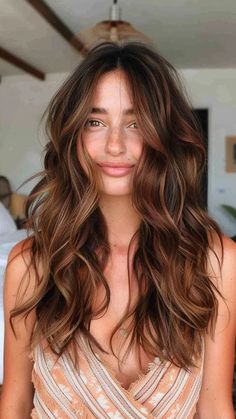 Woman with long, wavy brown hair and a gentle smile, wearing a light-colored top. Brown Partial Highlights, Warm Light Brown Hair Honey Caramel, Warm Brown Hair With Highlights, Balayage Rose Gold, Low Maintenance Balayage, Light Brown Balayage, Rose Gold Highlights