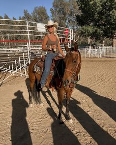 a woman riding on the back of a brown horse