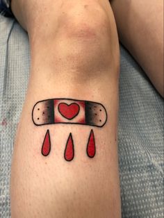 a person with a tattoo on their leg that has blood dripping from it and a heart in the middle