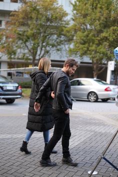 a man and woman walking down the street