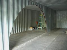 an empty storage room with ladders in it