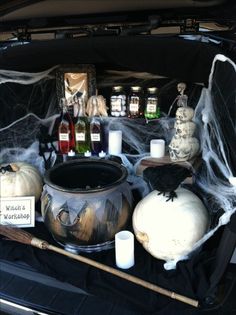 halloween decorations in the trunk of a car, including pumpkins and witches'web