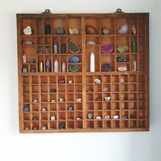 a wooden shelf filled with lots of rocks