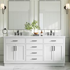 a white bathroom with double sinks and mirrors