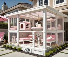 a doll house with pink furniture and white cats on the roof, in front of a home