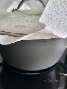 an ironing board on top of a stove with a towel hanging from it's side