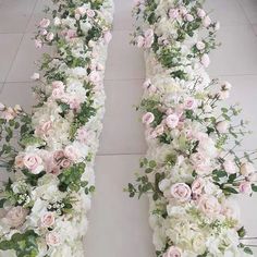 two rows of white and pink flowers on the floor