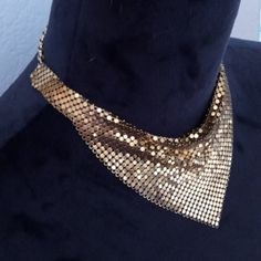 "WHITING & DAVIS Gold Toned Small Choker Bib Oromesh Necklace. * Whiting & Davis * 100% Authentic * True Vintage 1970's Disco * RARE Style! Choker Bib * Gold Toned Chainmail Oromesh. * Starts Off as a Choker with a Small Bib in the Center. * Chain & Hook Closure * Whiting & Davis Signature Leaf Charm on Chain End. * Pre-Owned Excellent Wearable Condition. No Issues. * Measurements: Side Choker Width 1/2\" Side Choker Length Each Side 1.5\" Bib Length 6.5\" Bib Height 4\" Connecting Chain Each Side  2.5\"" Handmade Gold Bib Necklace Choker, Gold Bib Choker Costume Jewelry, Vintage Gold Bib Necklace Gift, 1970s Necklace, Gold Bib Necklace, 1970s Disco, Vintage Disco, Bib Necklaces, Leaf Charms