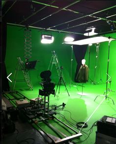 a green screen studio with lights and lighting equipment