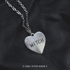 Show everyone that you're literally that witch with this heart labelled with 'WITCH' necklace! This is a beautiful gothic fashion statement! - Material Type: Zinc Alloy - Chain Length: 20 inches - Pendant Size: 2.5 cm by 2.5 cm All necklaces are inside a material pouch and then carefully placed inside an envelope lined with bubble wrap to ensure no damage in transit. *Please note that although item photography is as accurate as possible, some screens may portray the item colour slightly differen Silver Grunge Jewelry For Valentine's Day, Gothic Metal Heart Necklace, Grunge Heart-shaped Jewelry For Halloween, Gothic Silver Heart Charm Necklace, Gothic Heart Pendant Necklace, Gothic Heart Necklaces With Heart Charm, Silver Gothic Heart Charm Necklace, Grunge Necklace For Valentine's Day Gift, Silver Gothic Heart Necklace