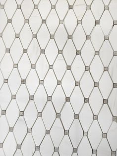 an image of a white tile pattern that looks like hexagonals on the wall