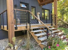 there is a small house with stairs leading up to the front door