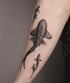 an arm with some sharks on it