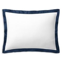 a white and blue pillow on a white surface with a black border around the edges