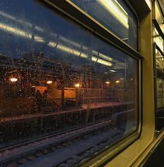 the rain is falling on the window of a train