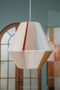 a book like light hanging from a ceiling