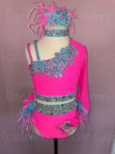 a pink dress with blue and silver beads on the neck, and fringes around the waist