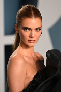 a woman with very long hair wearing a black dress