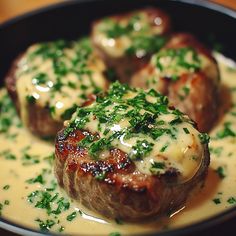 three meatballs covered in sauce and garnished with parsley on the side